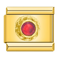 Gold charm with a red gemstone on a white background