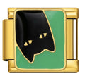 Gold charm with black and green design on a white background