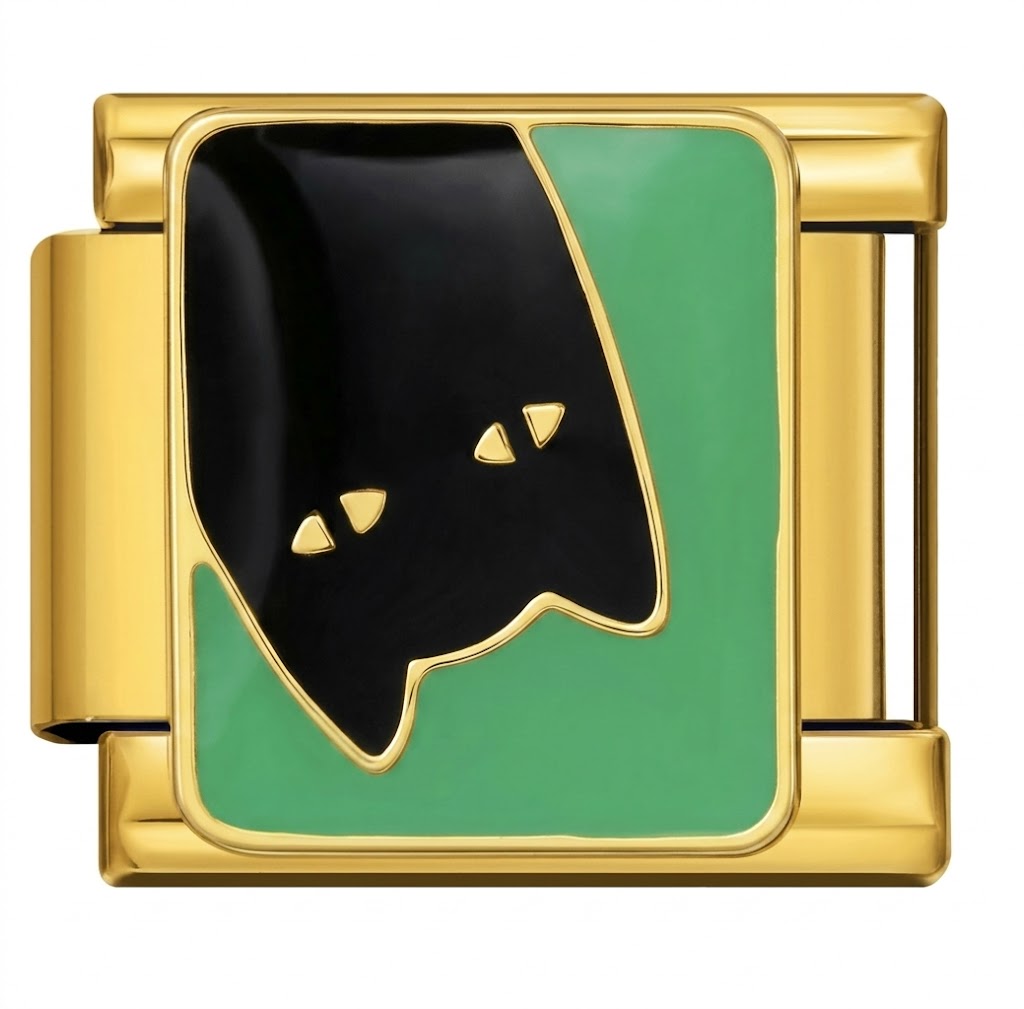 Gold charm with black and green design on a white background