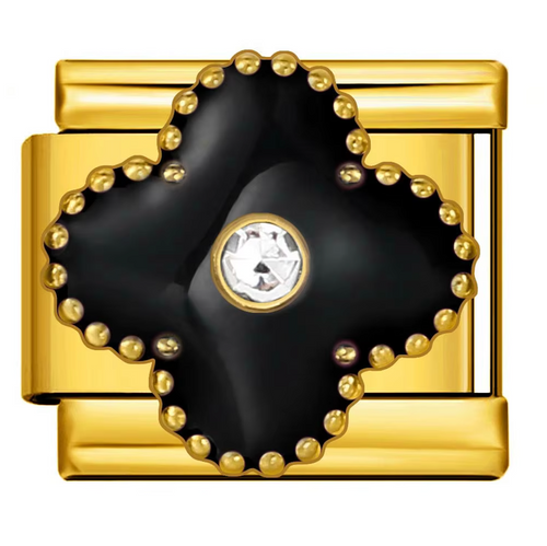 Gold and black decorative item with a central gemstone on a white background