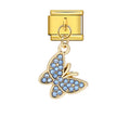 Gold butterfly charm with blue stones on a white background