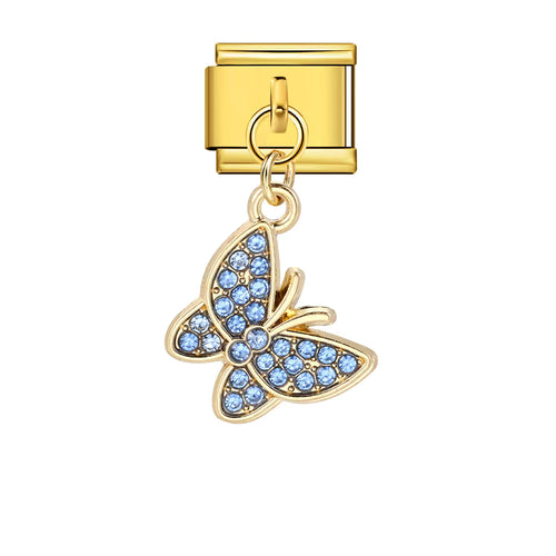 Gold butterfly charm with blue stones on a white background