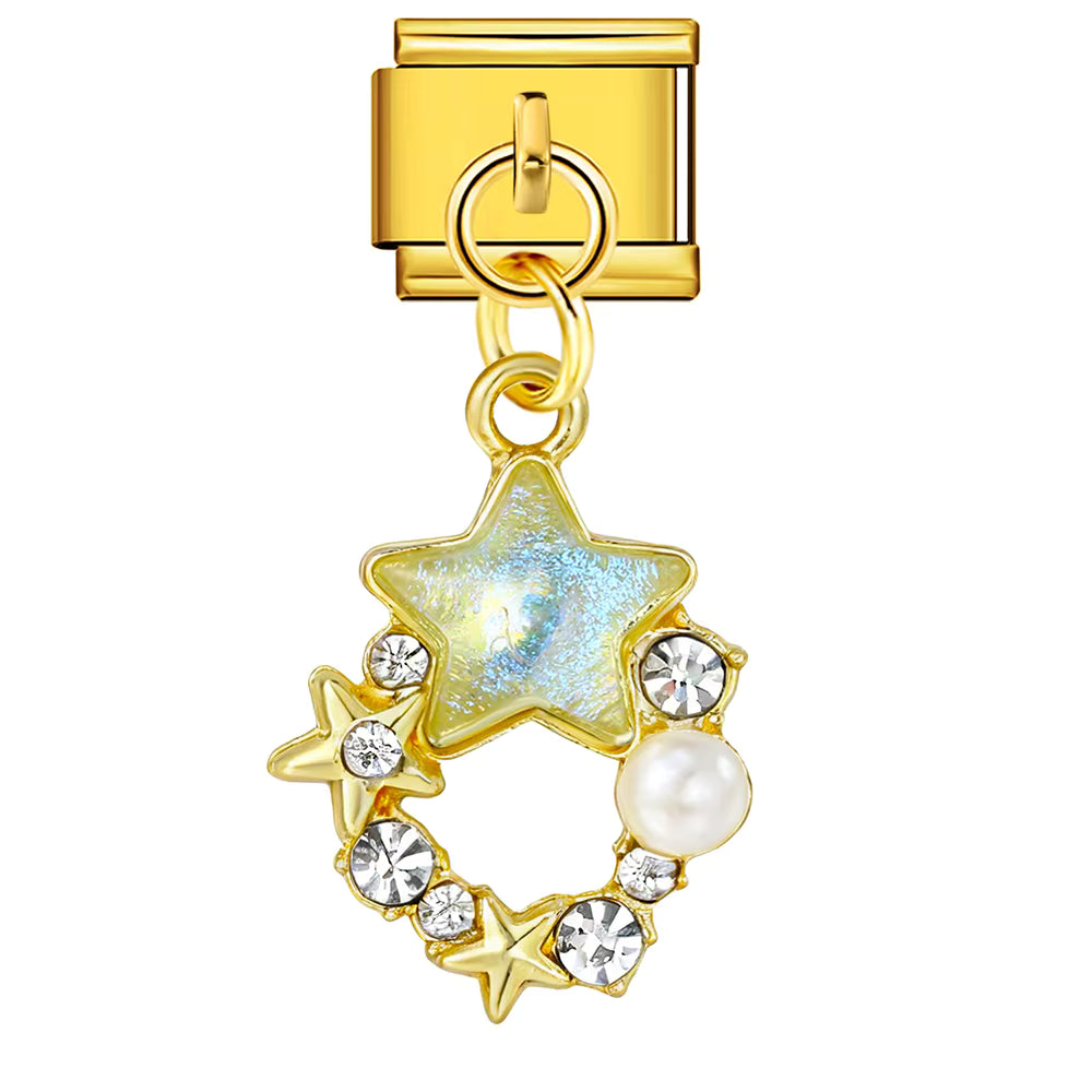 Gold charm with star design, pearl, and crystals on a white background