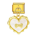 Gold heart-shaped charm with a bow on a white background