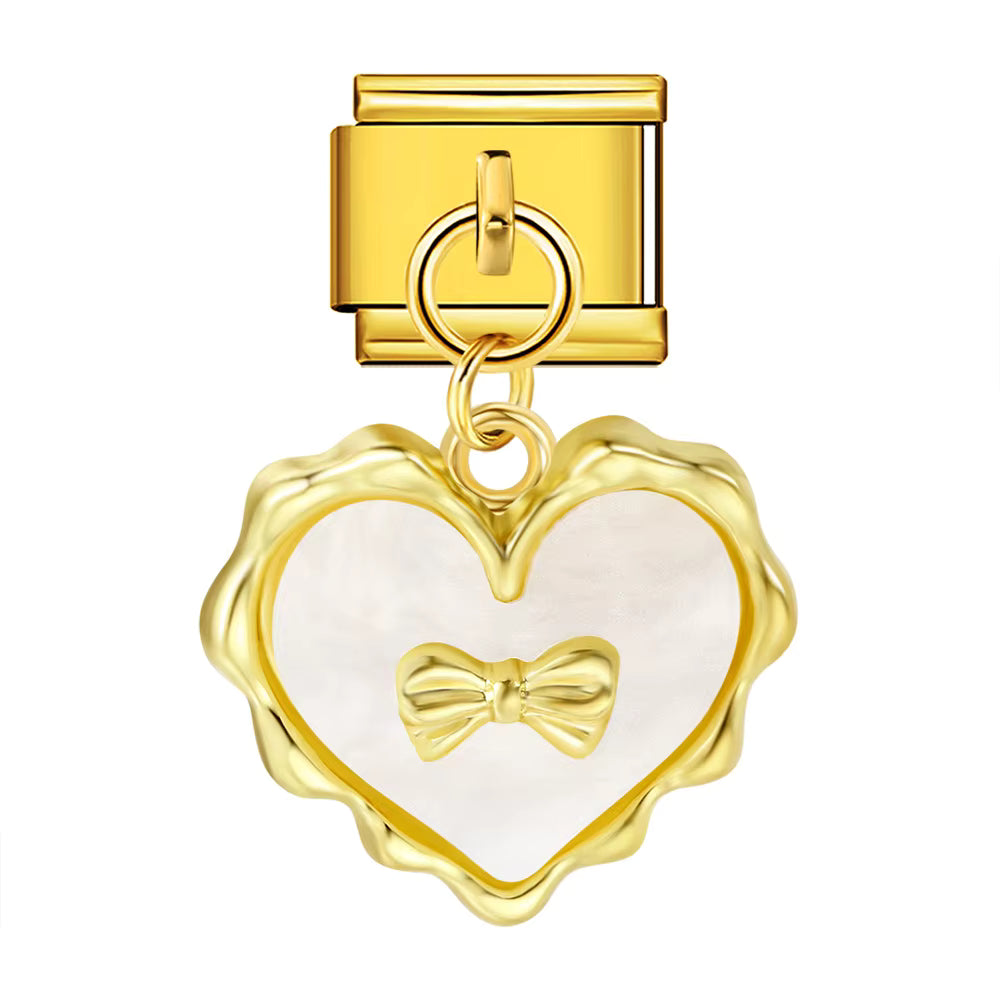 Gold heart-shaped charm with a bow on a white background