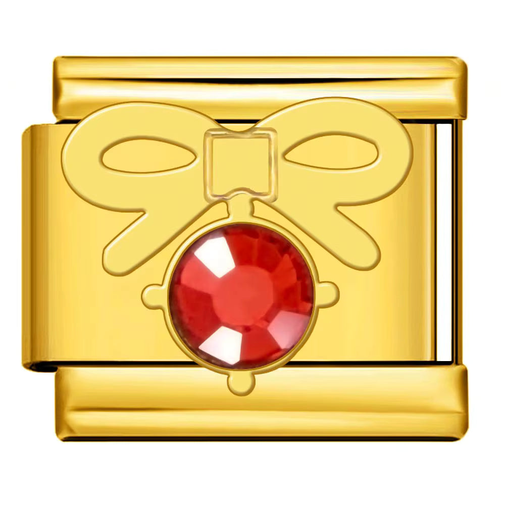 Gold bow with a red gemstone on a white background