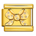Gold bow-shaped charm with polka dots on a white background