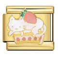 Gold charm with a white cat, pink strawberry, and pink paw prints on a white background