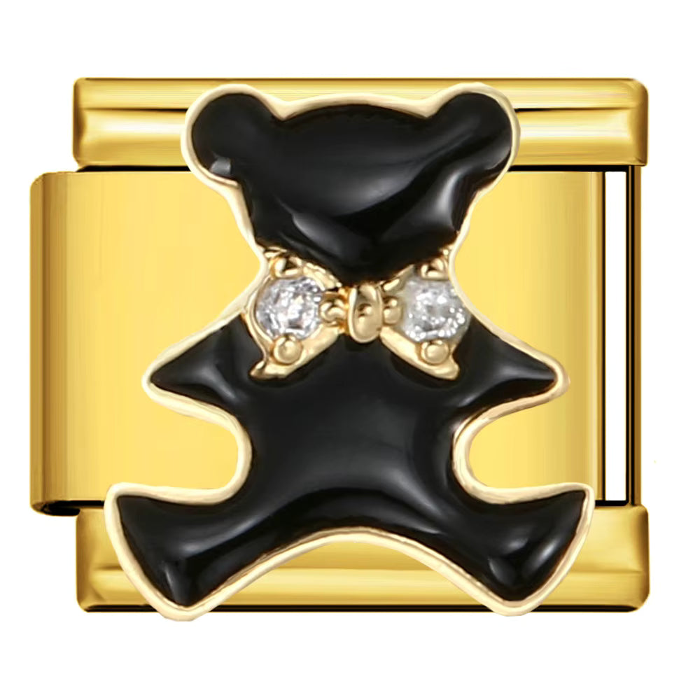 Gold charm with black bear and crystal bow tie on a white background