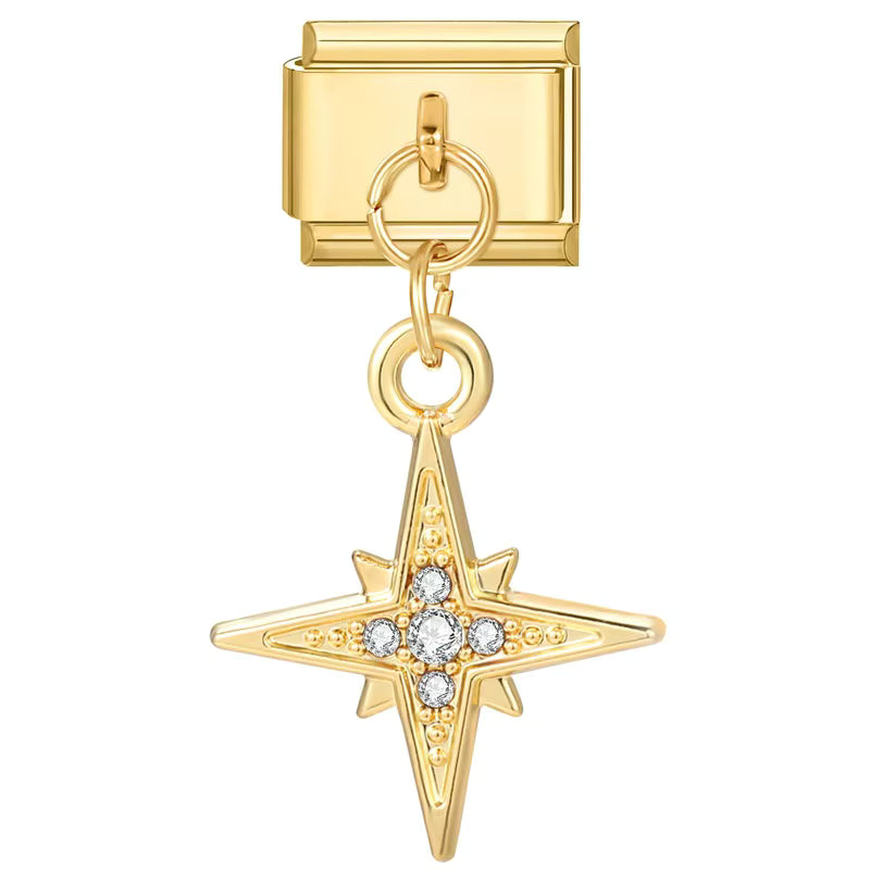 Gold charm with star design and embedded stones on a white background