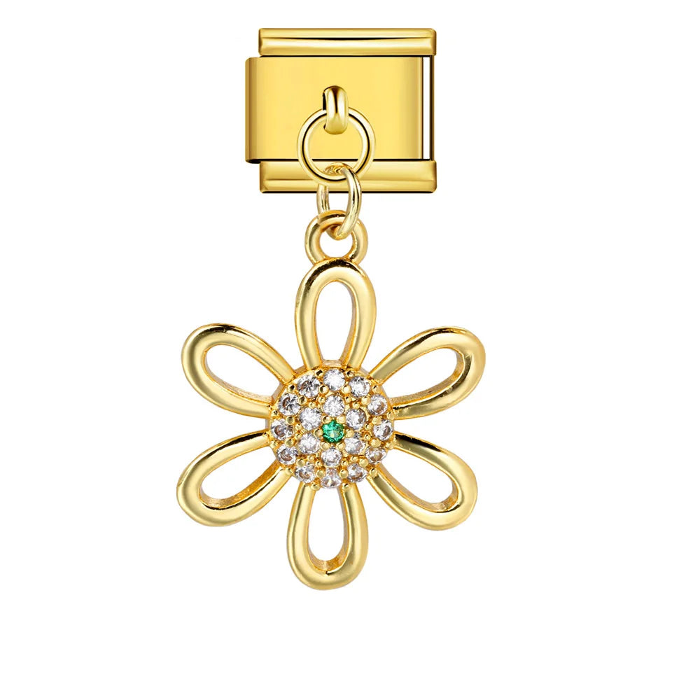 Gold charm with Gold flower-shaped charm with a green gemstone on a white background