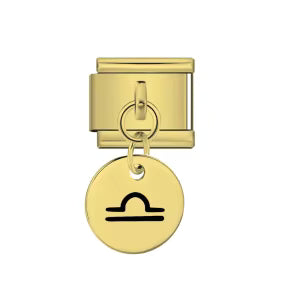Gold charm with a black symbol on a white background