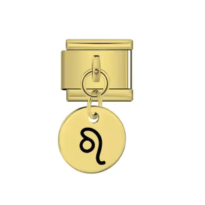 Gold charm with a black astrological symbol on a white background
