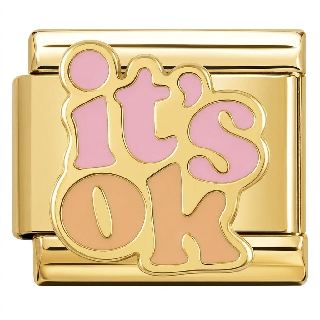 Gold charm with 'it's ok' in pink and brown on a white background