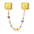 Gold charm with colorful beads on a white background