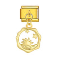 Gold charm with a sun and star design on a white background