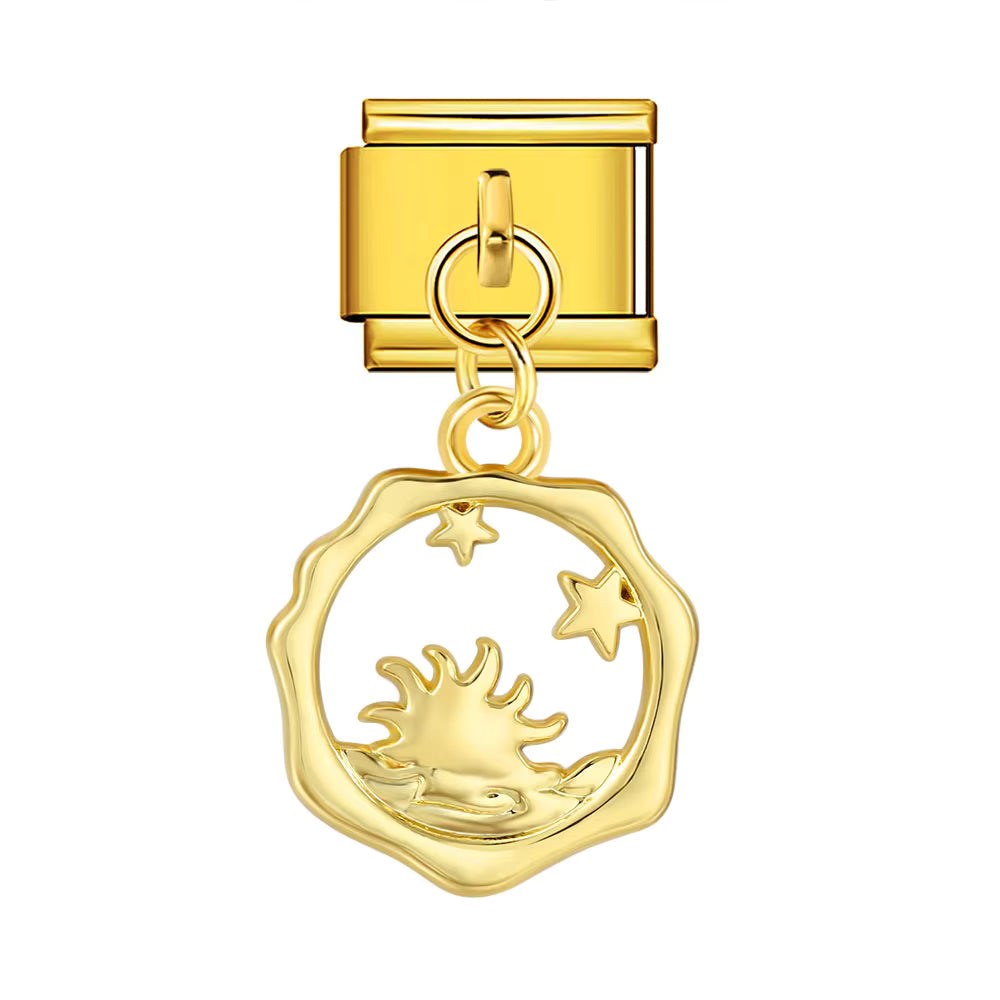 Gold charm with a sun and star design on a white background