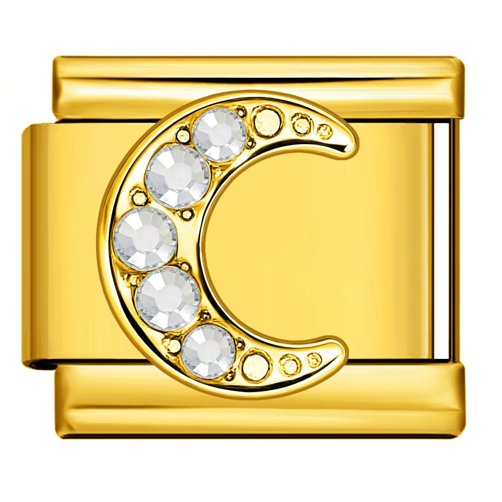 Gold charm with a crescent moon design and embedded crystals on a white background