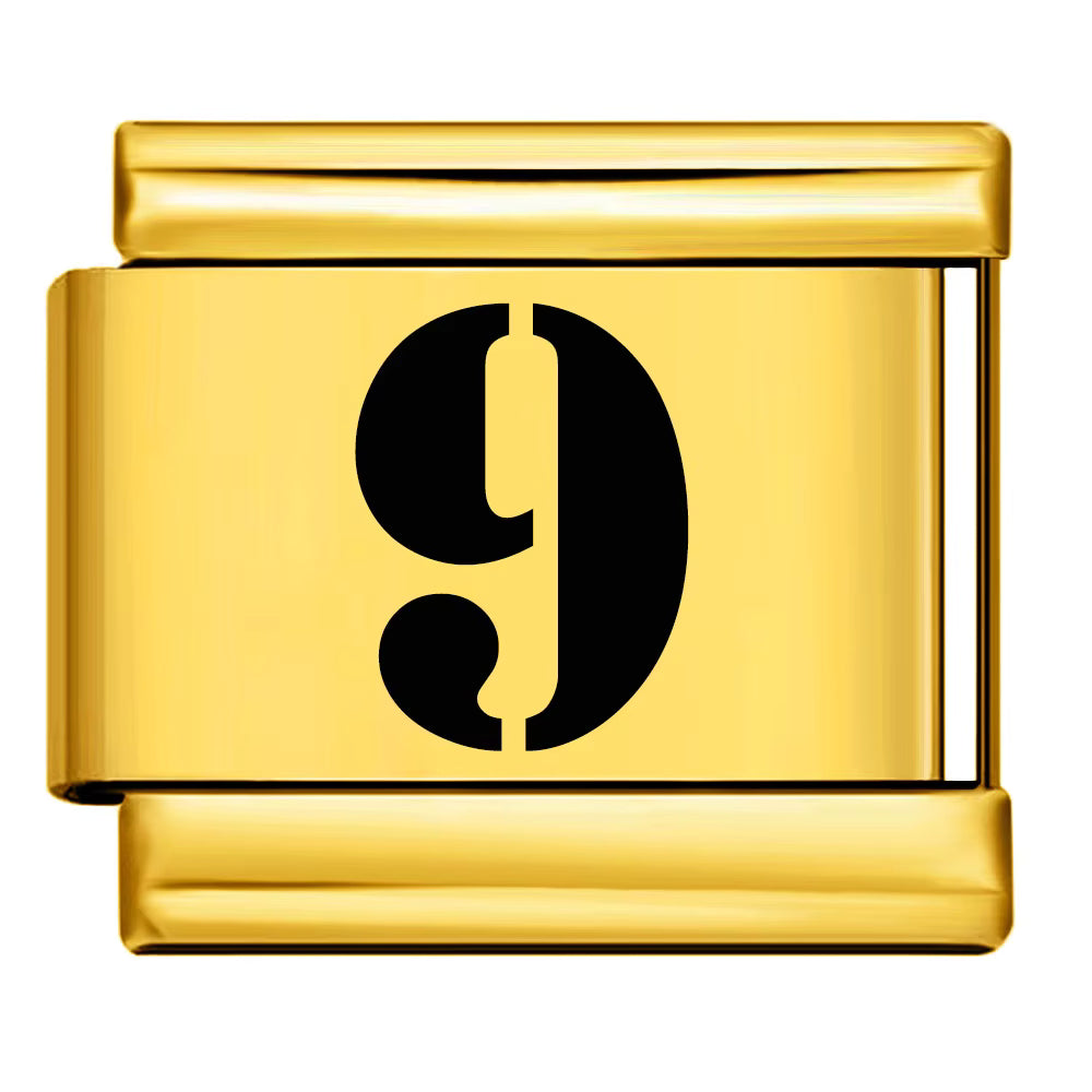 Gold charm with the number 9 on a white background