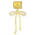 Gold tassel with pearl embellishments on a white background