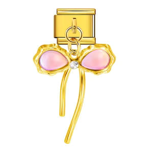 Gold bow-shaped earring with pink stones on a white background