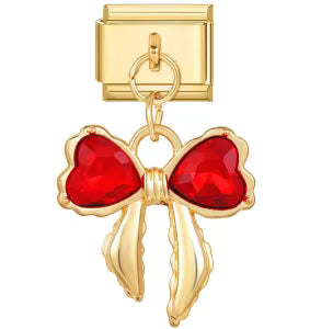 Gold charm with a red heart design on a white background