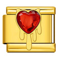 Gold charm with a red heart-shaped gem on a white background