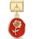 Gold charm with a red background and gold rose design on a white background