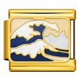 Gold charm with a blue and white wave design on a white background