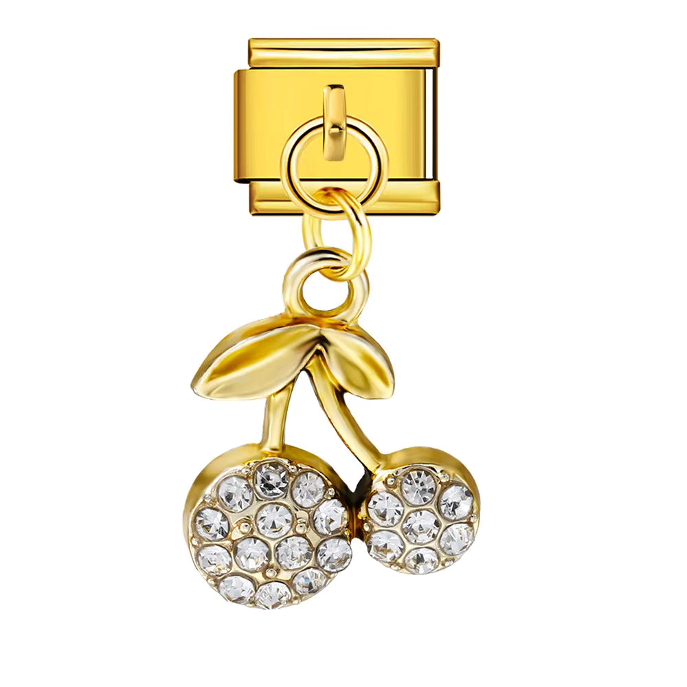 Gold charm with a cherry design featuring crystals on a white background