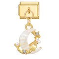 Gold charm with moon and star design on a white background