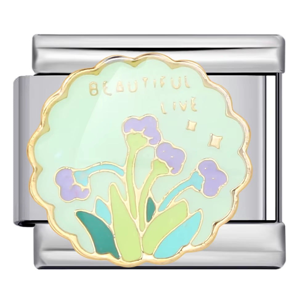 Silver charm with floral design and 'BEAUTIFUL LIVE' text on a white background