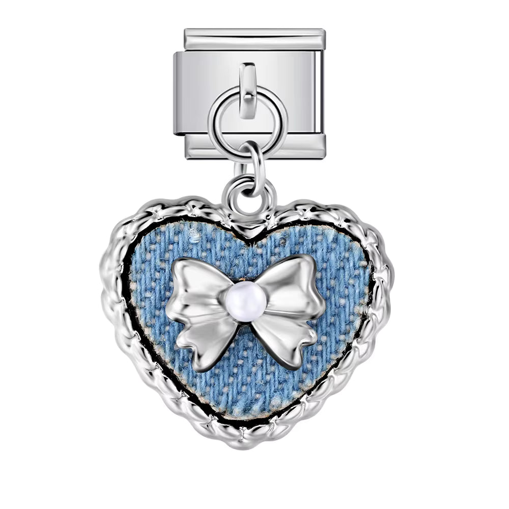 Heart-shaped charm with denim texture and silver bow on a white background