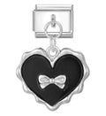 Heart-shaped with a black center and silver bow design on a white background