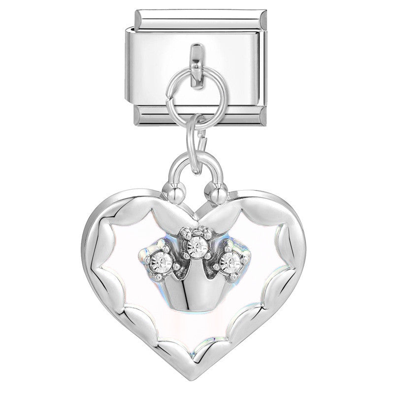 Silver heart-shaped charm with embedded stones on a white background