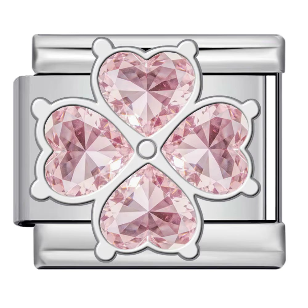 Silver charm with pink heart-shaped crystals on a white background