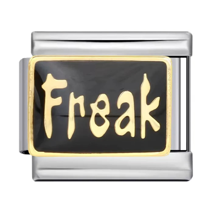 Freak quote charm with gold lettering on black enamel background in gold-tone frame