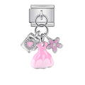 Silver charm with pink dress, camera, and flower on a white background