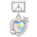 Silver charm with heart-shaped gem, pearls, and star on a white background