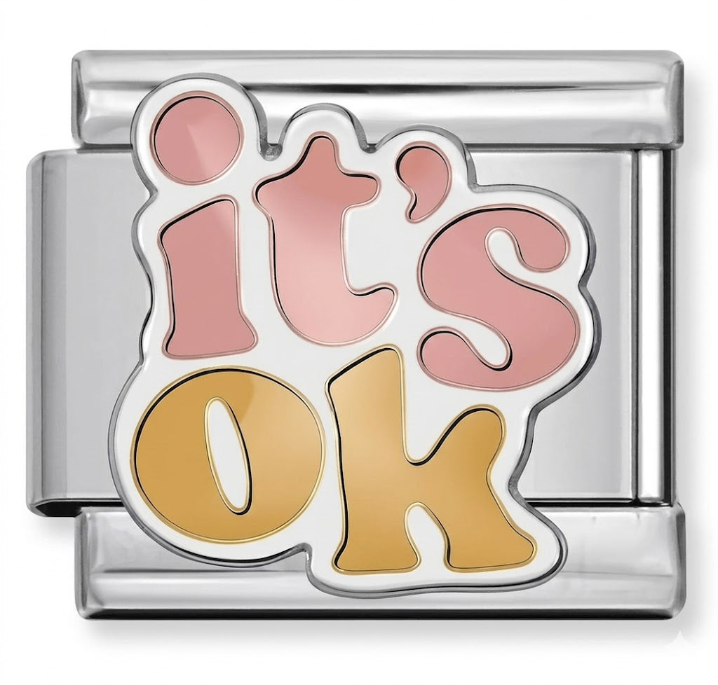 silver charm with 'it's ok' text in pink and gold on a white background