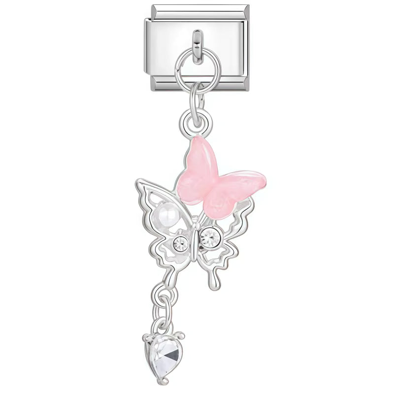 Silver charm with pink butterfly and clear gem on a white background