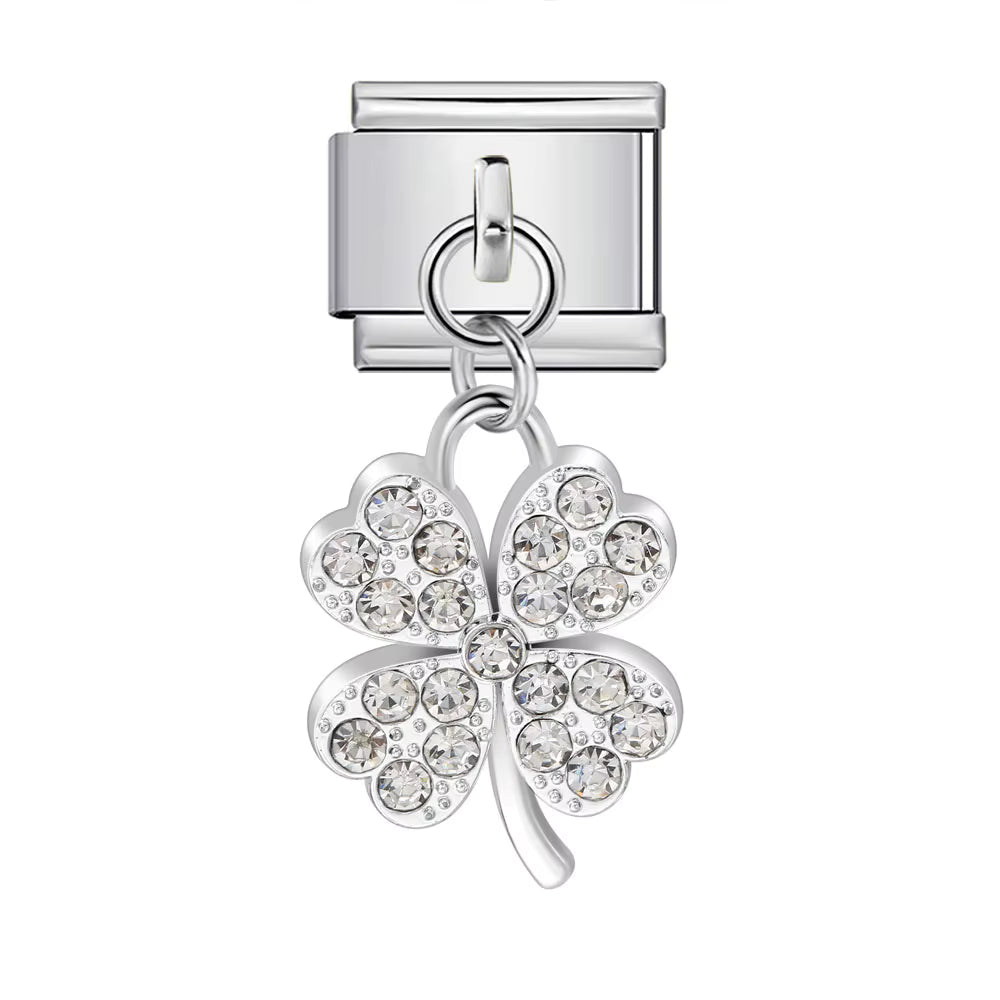 Silver charm with a four-leaf clover design on a white background
