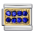 Jewelry charm with blue gemstones and gold accents on a white background