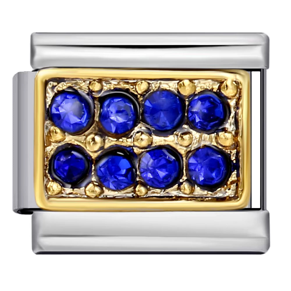 Jewelry charm with blue gemstones and gold accents on a white background