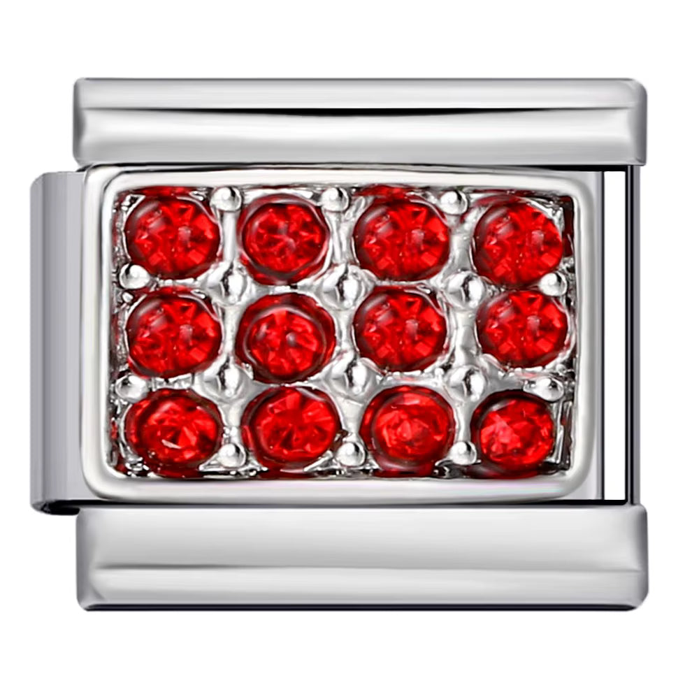 Silver charm with red gemstones on a white background