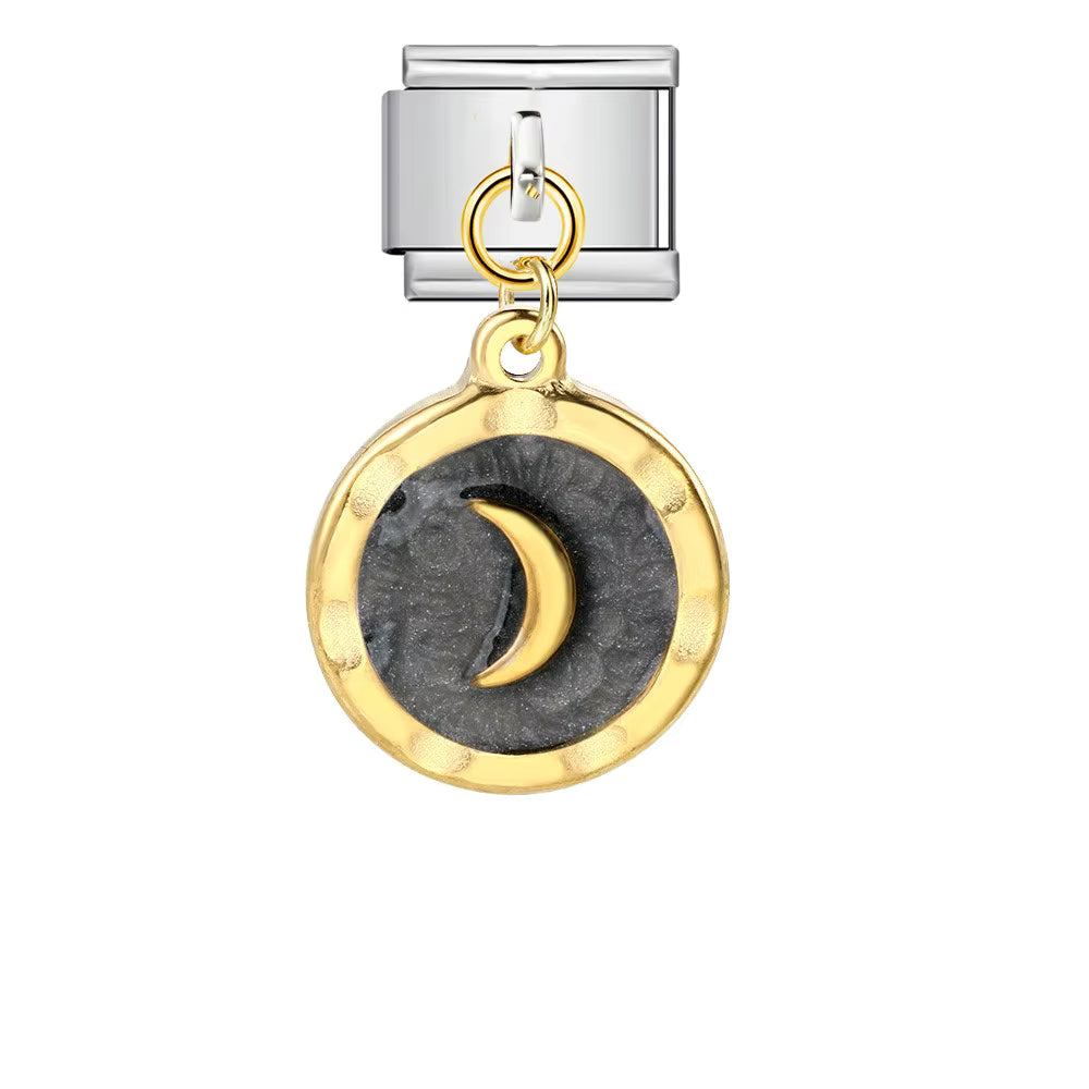 Silver charm with a moon design on a white background