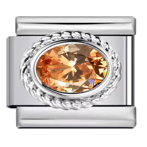 Silver charm with a large orange gemstone on a white background