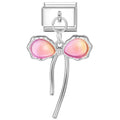 Silver charm with pink heart-shaped stones on a white background