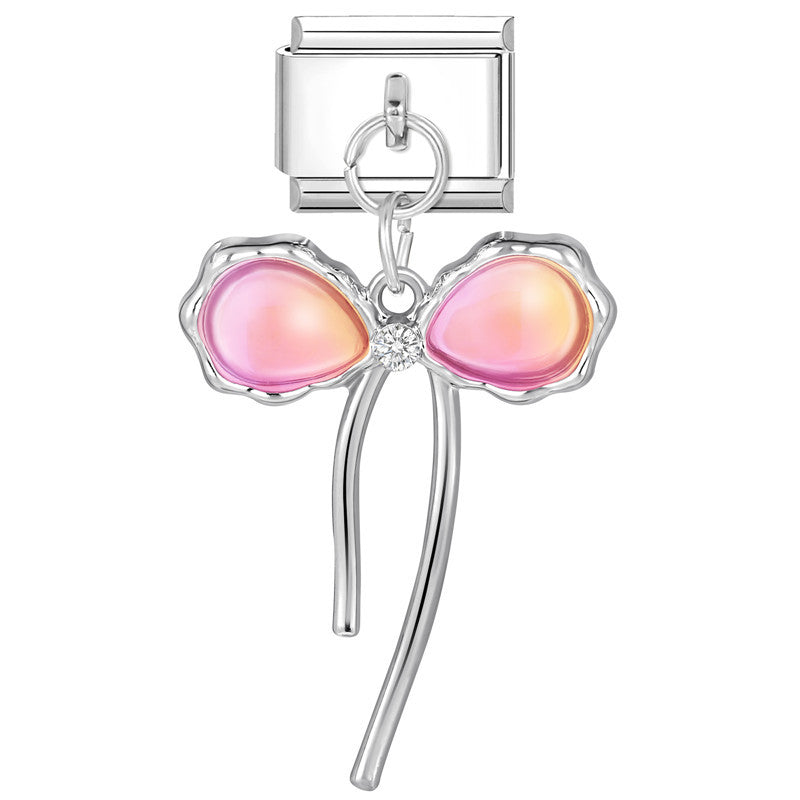 Silver charm with pink heart-shaped stones on a white background