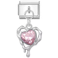 Silver charm with a pink heart-shaped gem on a white background